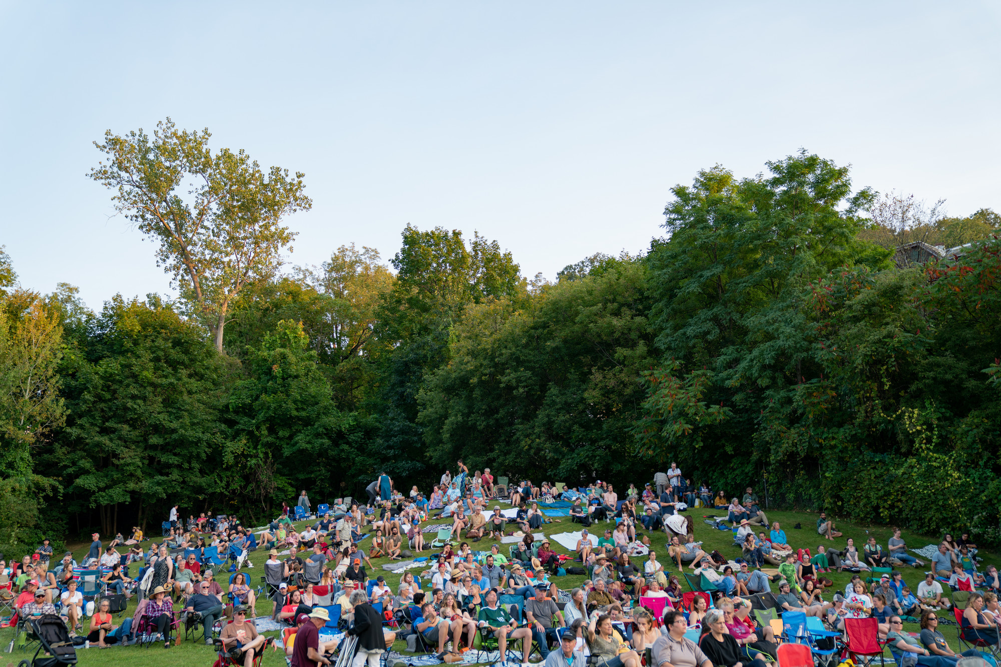Photograph of concert-goers on the lawn.